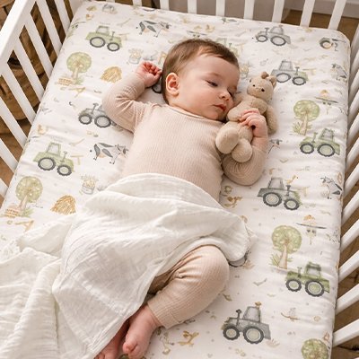 Bébé à moitié nuit sur drap housse lit bébé 