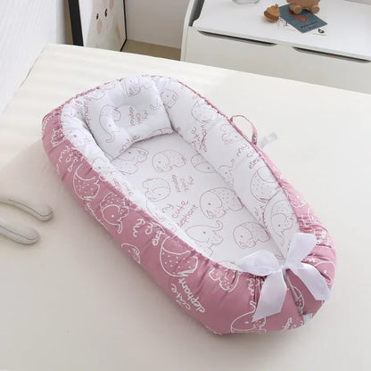 reducteur de lit bebe rose blanc
